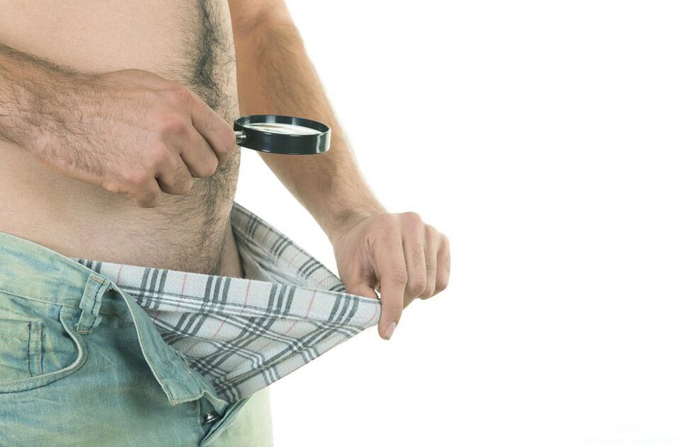 A man looks at the size of his penis